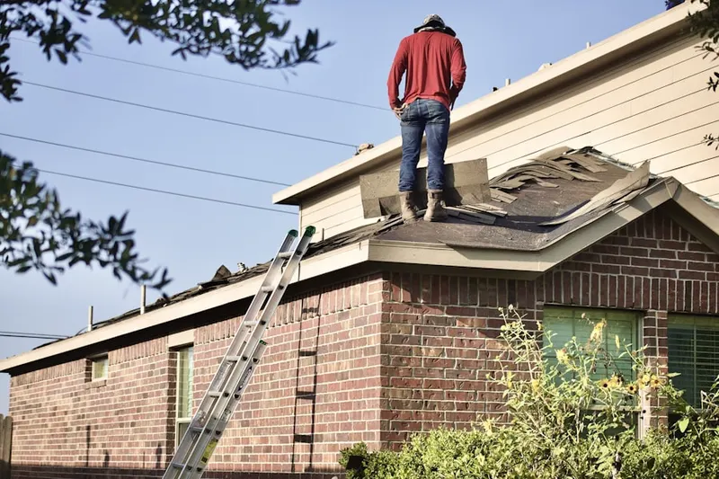 Professional roofer working on a residential roof in Fells Point